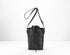Black textured bucket bag with a drawstring on a white background