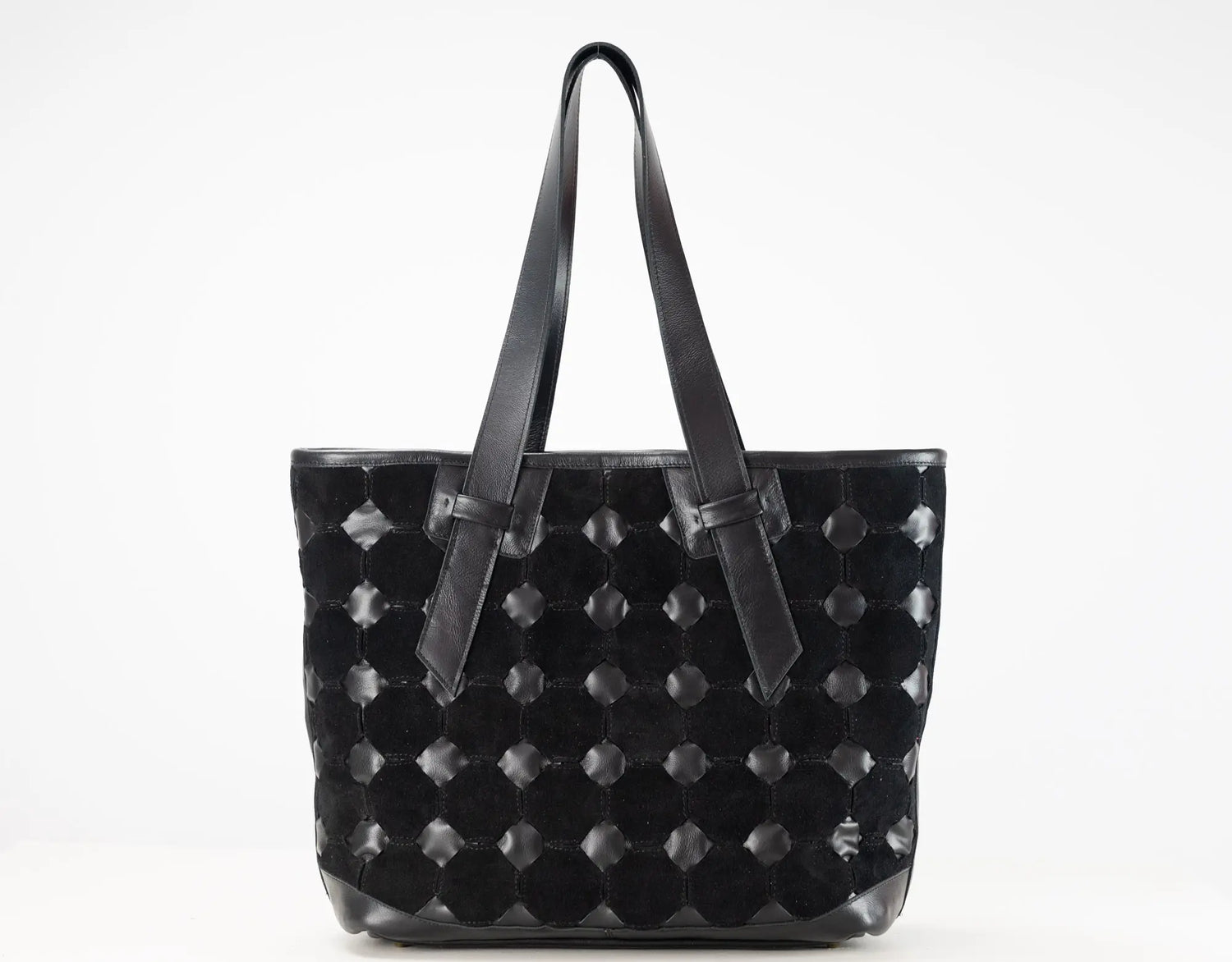 A black woven leather tote bag with long shoulder straps, photographed against a plain white background.
