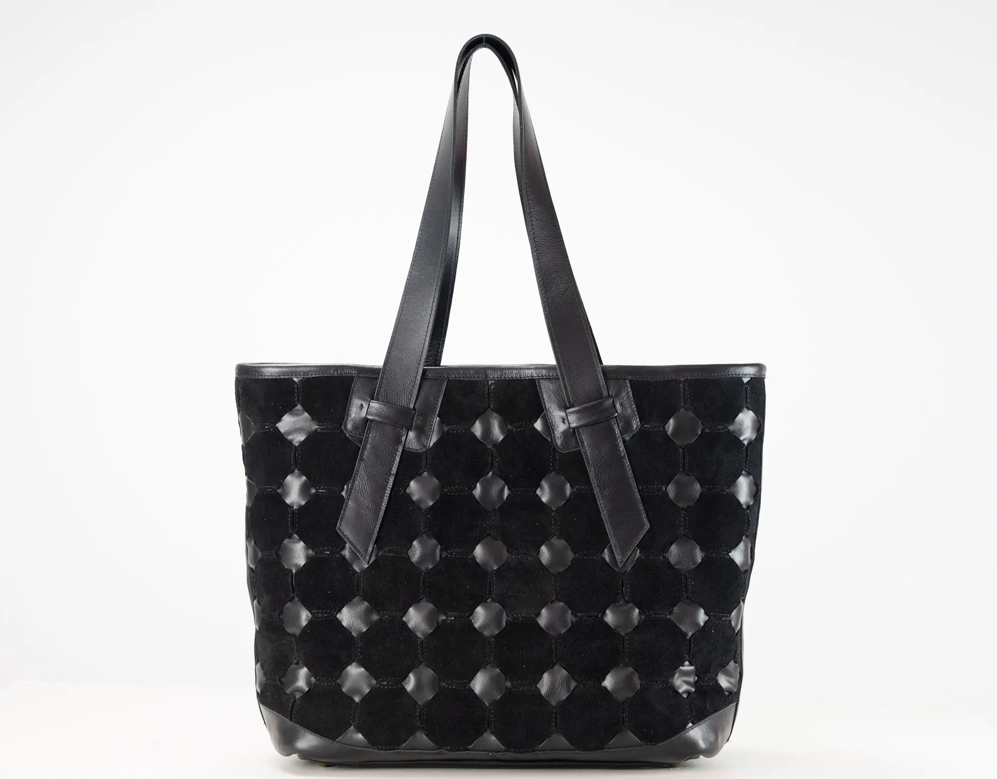 A black woven leather tote bag with long shoulder straps, photographed against a plain white background.