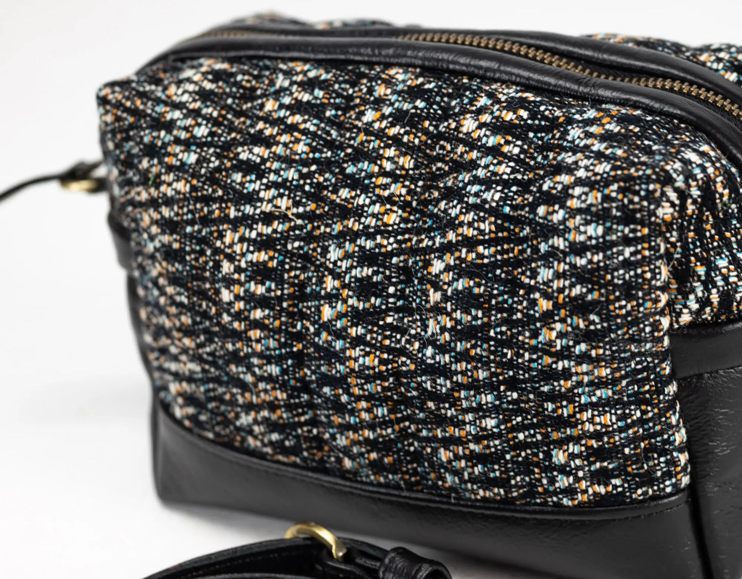 Black and gold patterned handbag on a white background