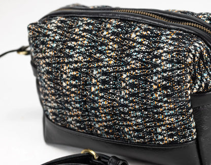 Black and gold patterned handbag on a white background