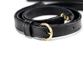 Black leather belt with a gold buckle on a white background