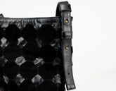 Black textured bag with a strap on a white background