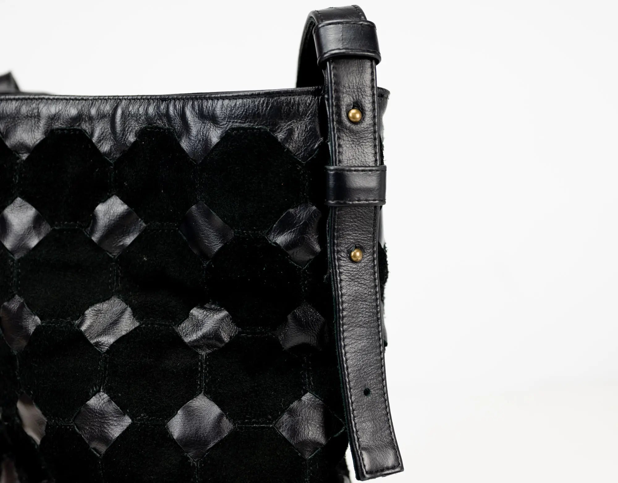 Black textured bag with a strap on a white background