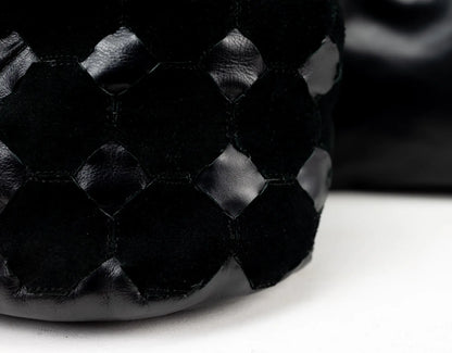 Close-up of a textured black shoe on a white background