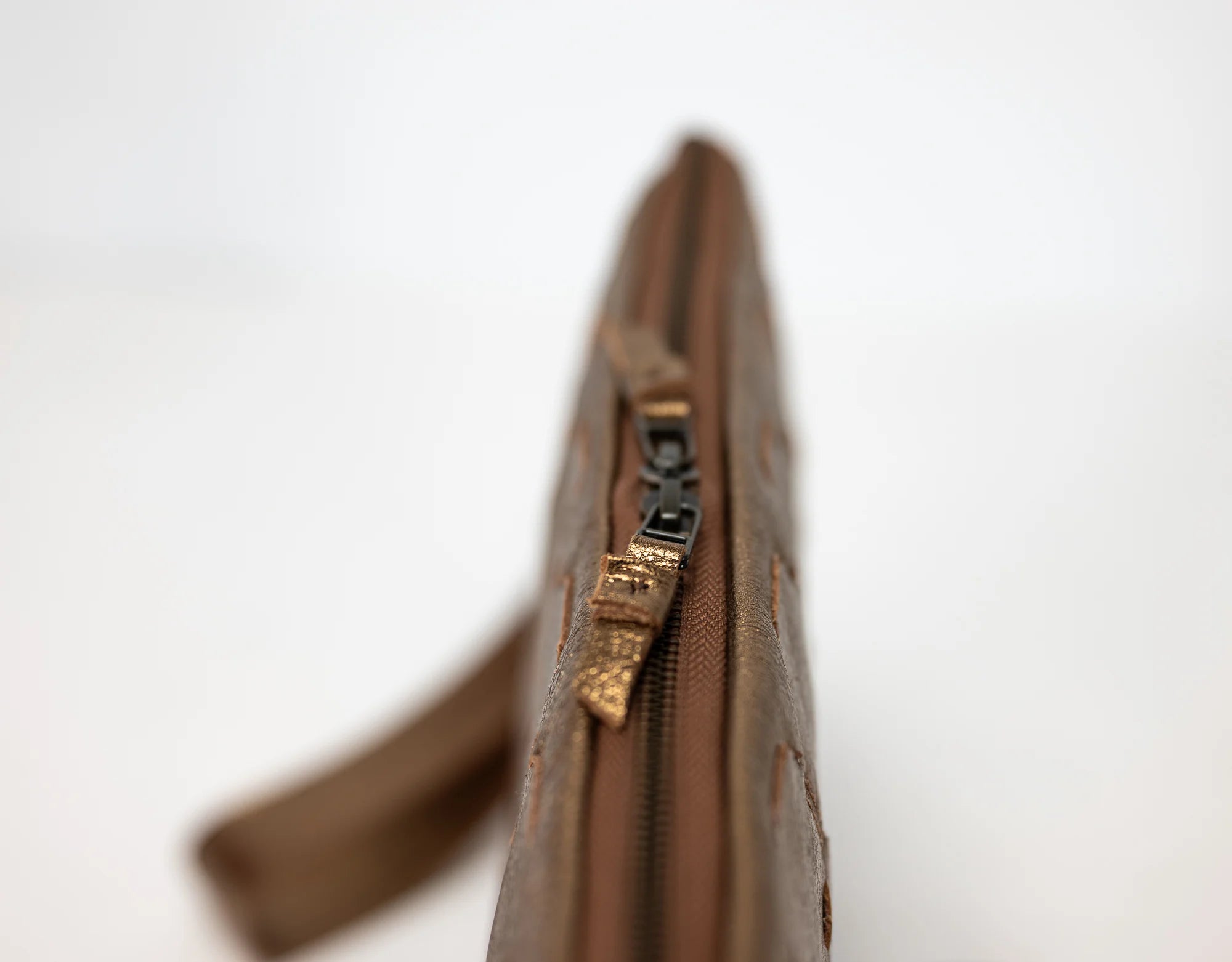 Brown zipper pouch on a white background