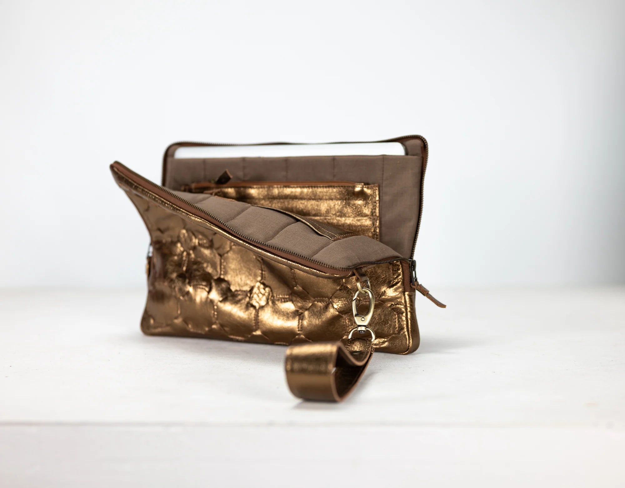 Gold and bronze clutch bag on a white background