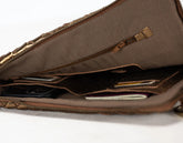 Brown leather bag with a zipper on a white background