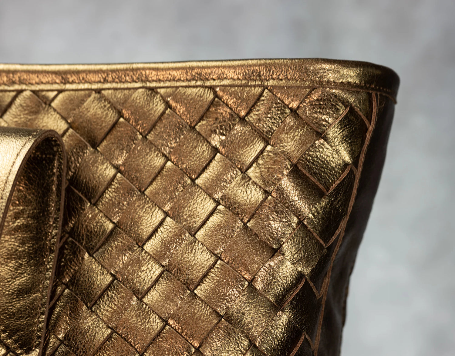 Close-up of a gold woven handbag