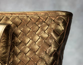 Close-up of a gold woven handbag