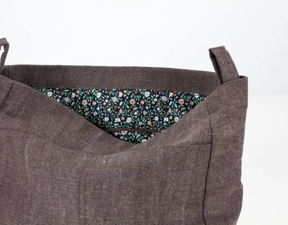 Brown fabric bag with floral lining on a white background