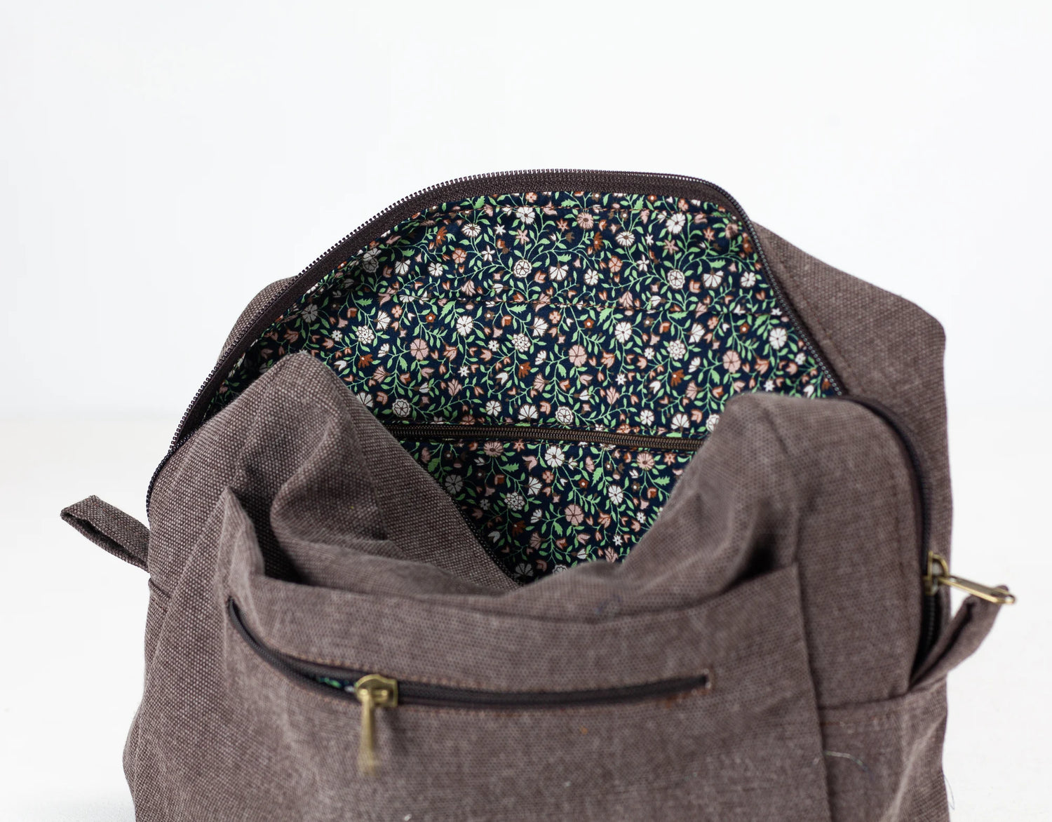 Brown cotton insert with floral interior lining on a white background 