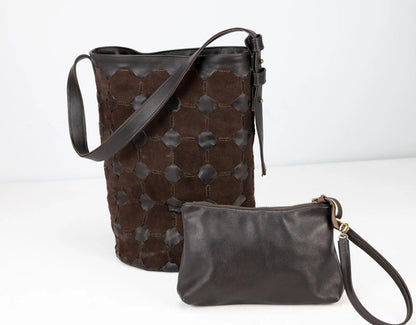 Brown leather bucket bag and matching wristlet on a white background