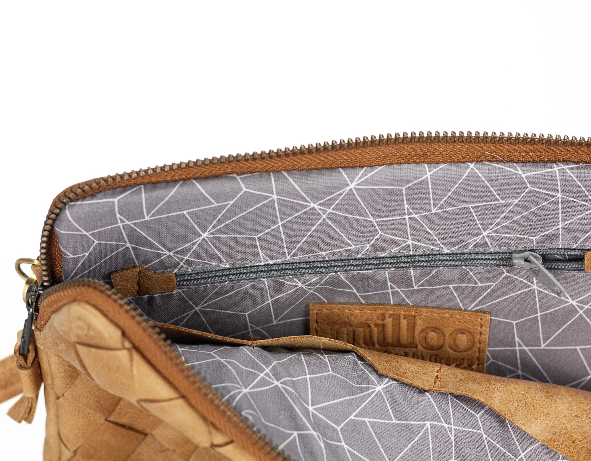 Close-up of a brown leather pouch with geometric patterned interior, featuring the brand milloo.