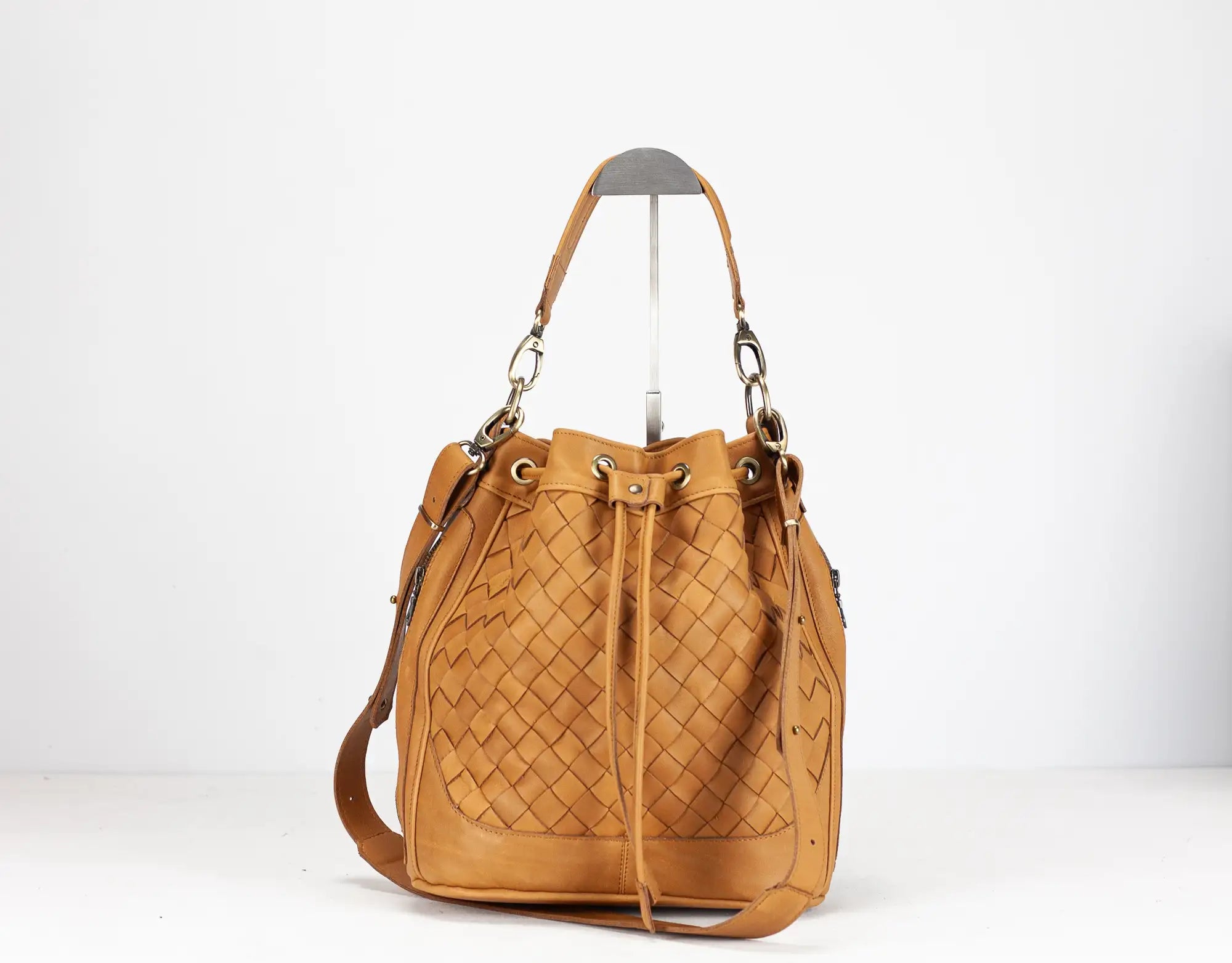 Tan woven handbag on a white background