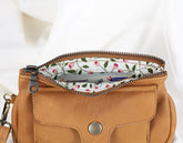Brown leather pouch with floral lining and Eurocard branding on a white background