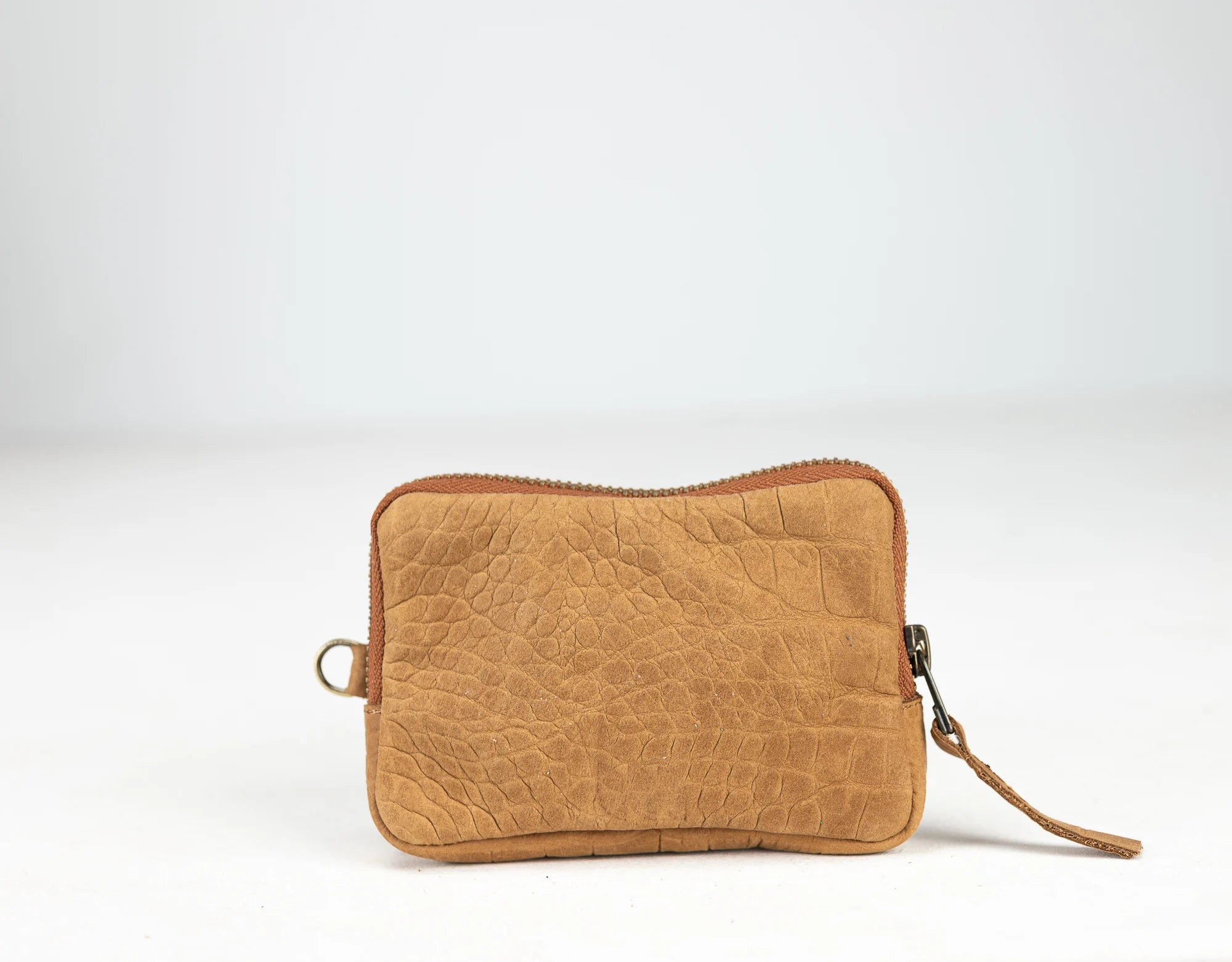 Brown leather clutch bag on a white background
