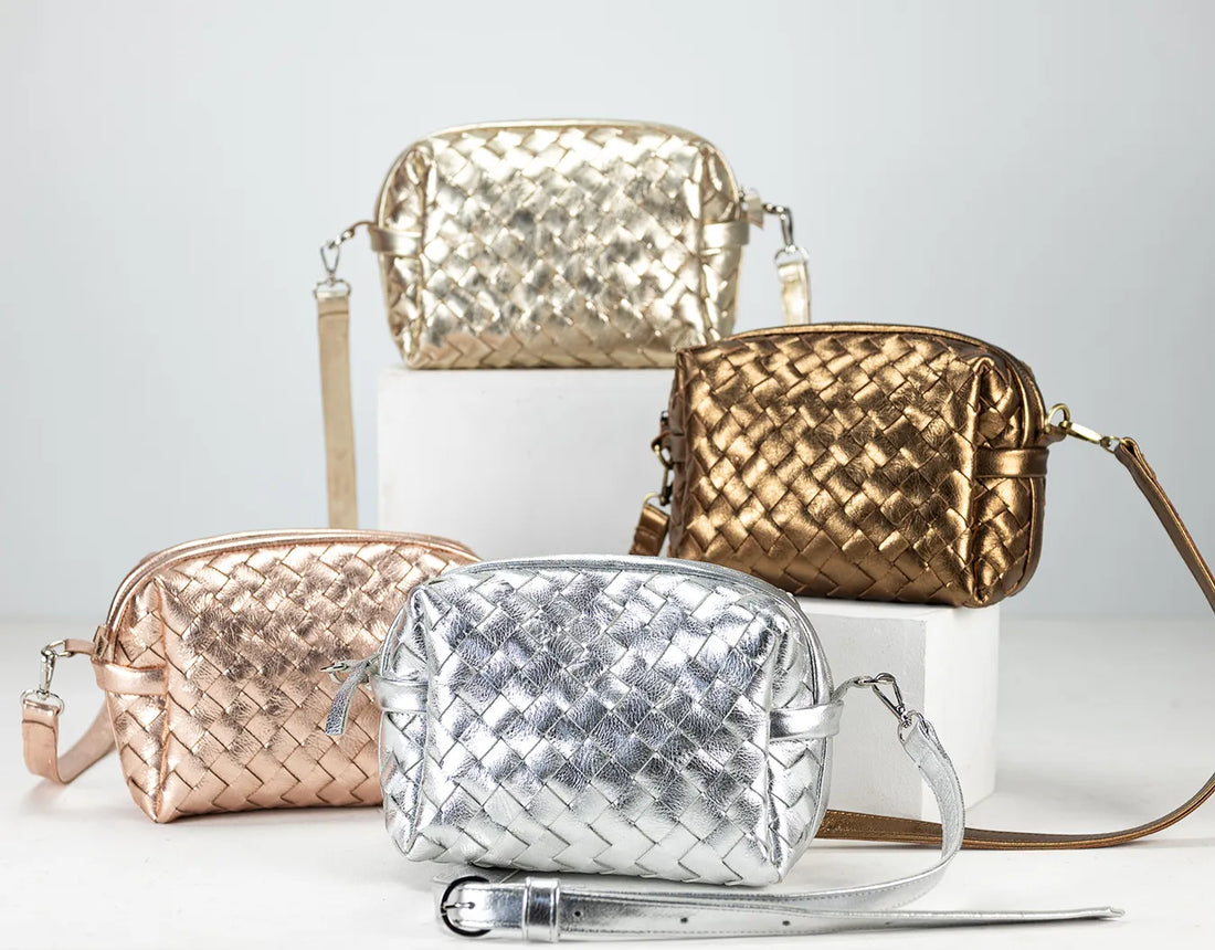 Four woven handbags in gold, silver, and rose gold on a light gray background