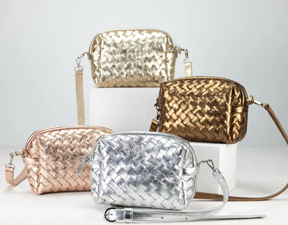 Four woven handbags in gold, silver, and rose gold on a light gray background