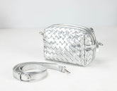 Silver woven handbag with a strap on a white background