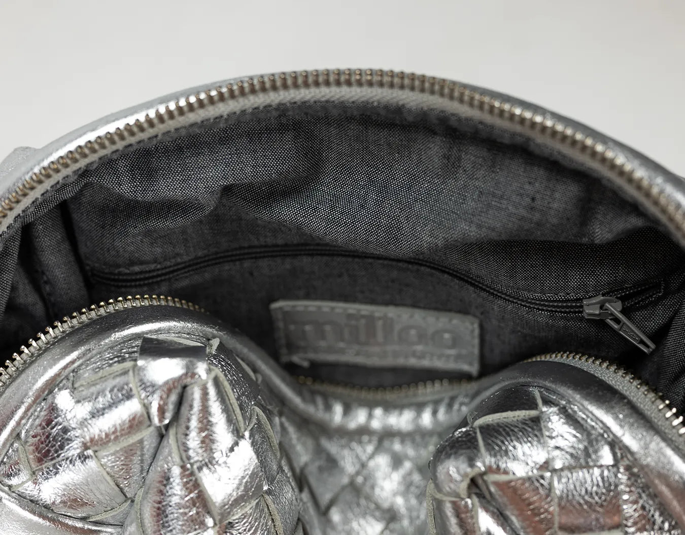 Silver insulated lunch bag with a visible brand logo on a white background