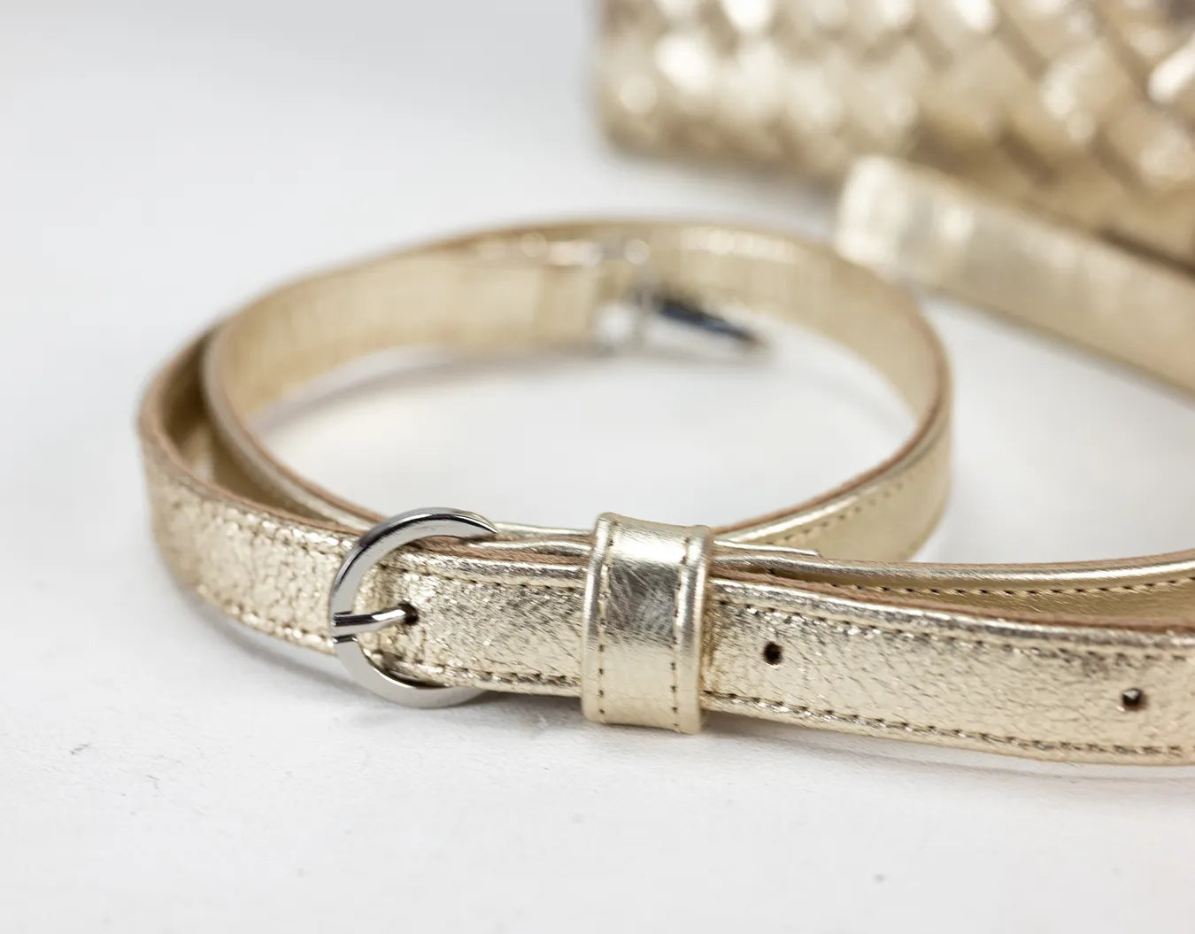 Gold metallic belt on a white background