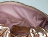 Close-up of a pink handbag with &