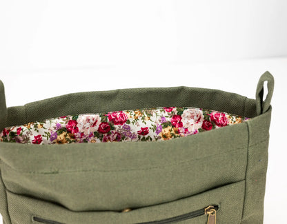 Green bag with floral lining on a white background