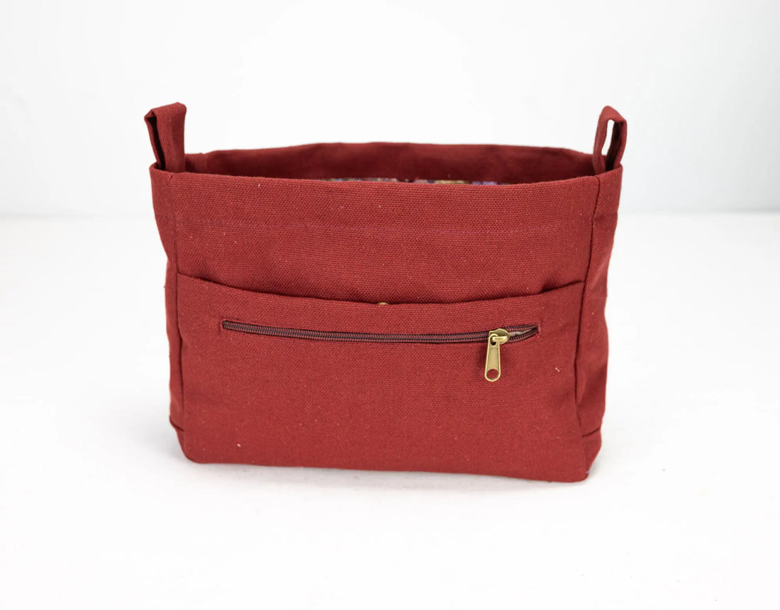 Red fabric bag with a gold zipper on a white background