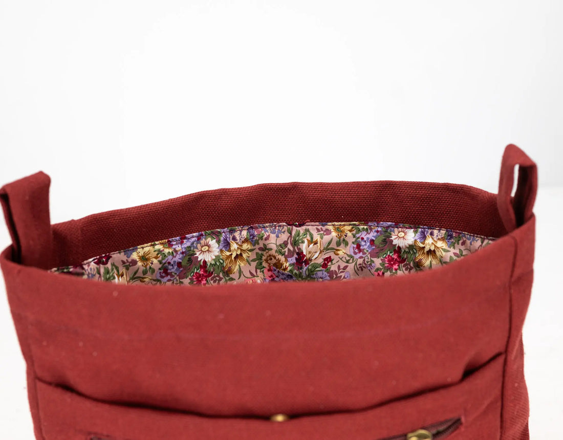 Red fabric basket with floral lining on a white background