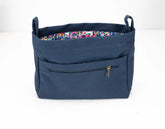 Blue bag with floral lining on a white background