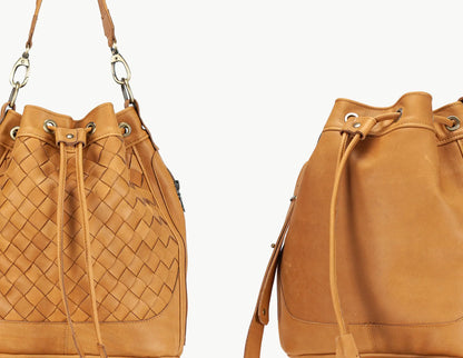 Brown leather bucket bag with woven pattern on a white background