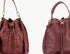 Two views of a maroon leather handbag with drawstring top.