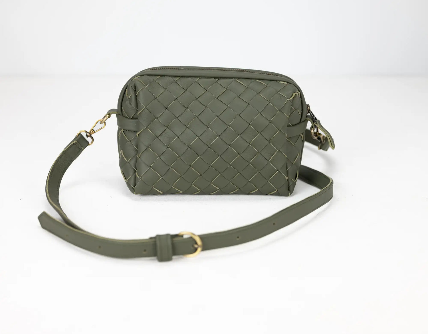 Green woven handbag with a strap on a white background