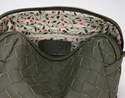 Green textured bag with floral lining on a white background
