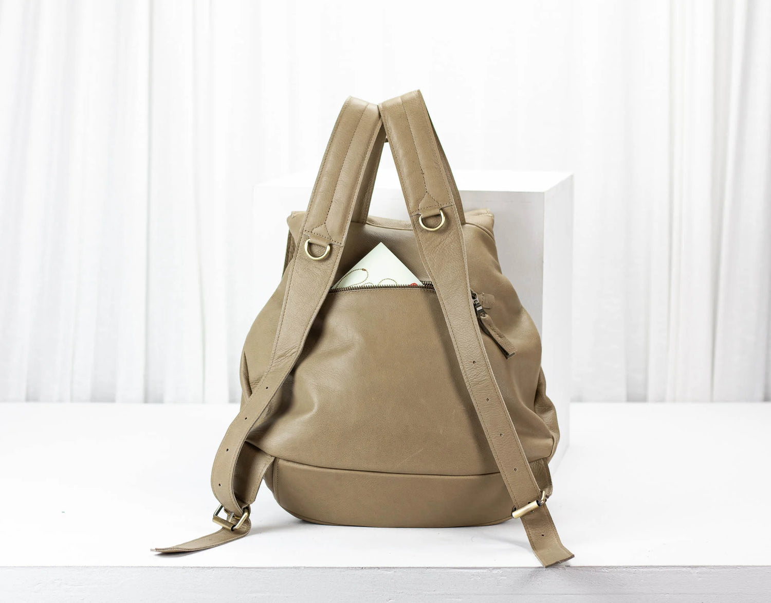 Beige backpack on a white background