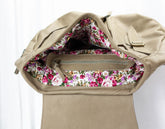 Beige handbag with floral interior on a white background