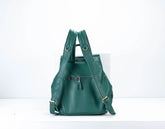 Green leather backpack on a white background