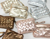 Collection of metallic handbags in gold, silver, and rose gold on a light background