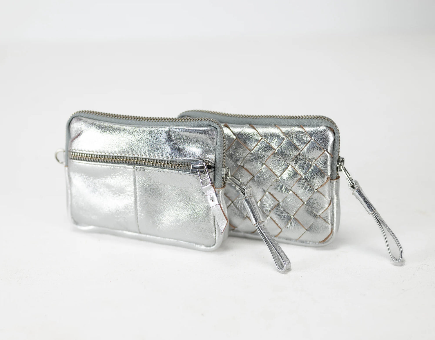Silver quilted wallet with a strap on a white background