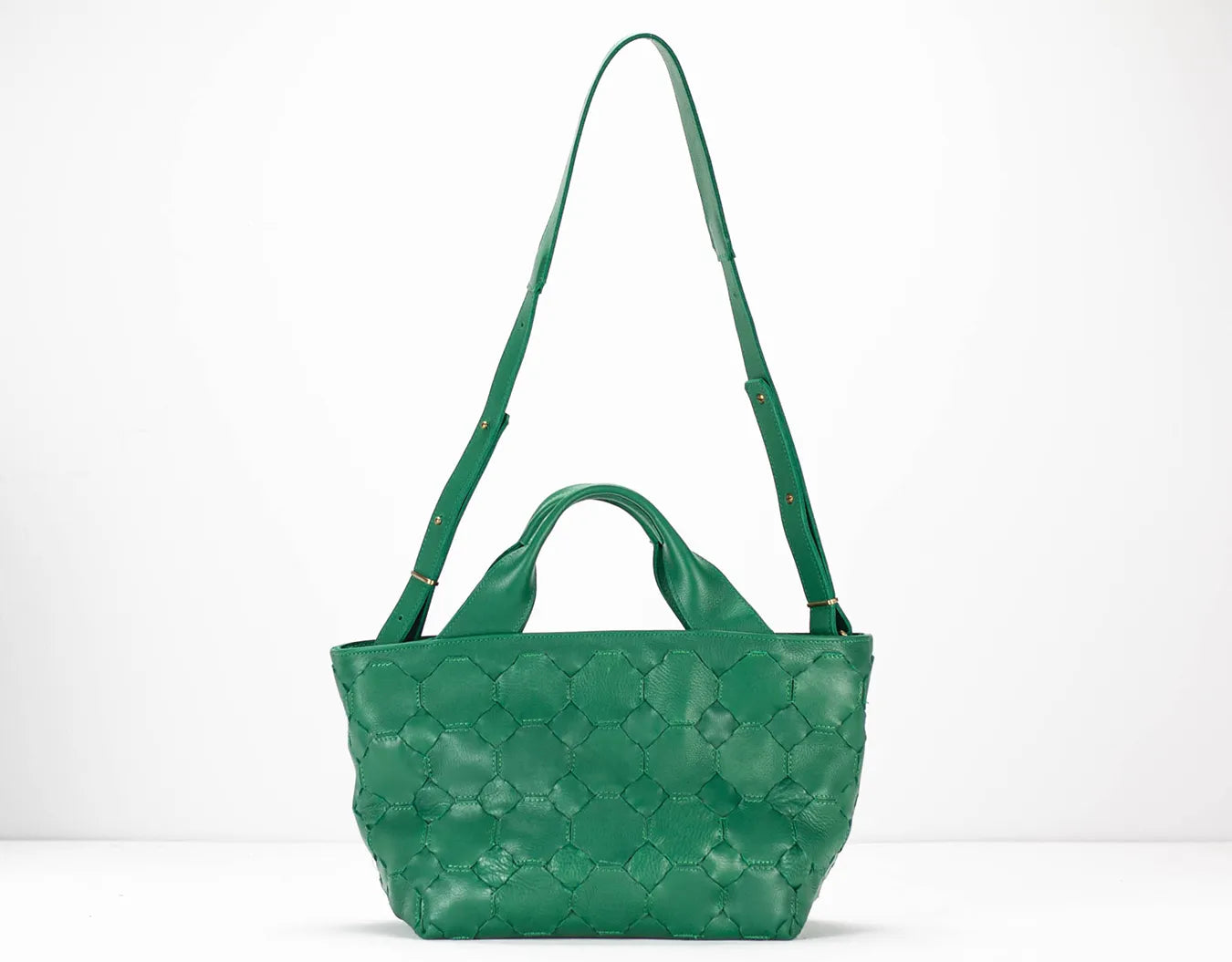 Green quilted handbag on a white background