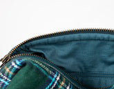 Close-up of a blue bag with a zipper, showing the interior.