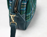 Green plaid bag with gold zipper pull on a white background