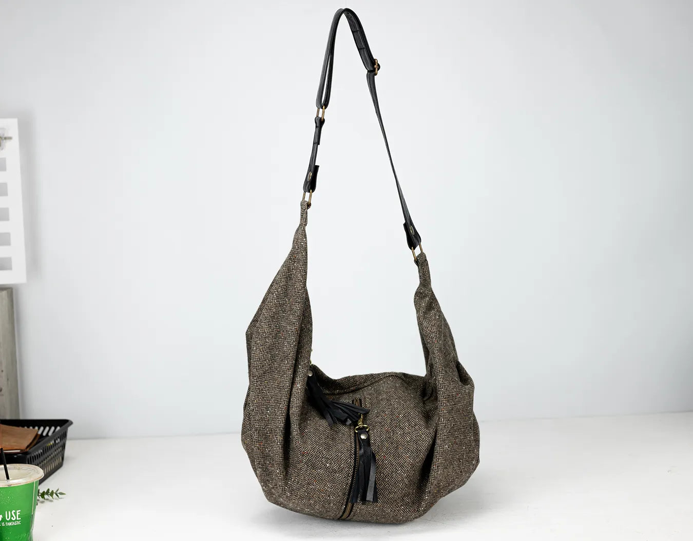 Gray shoulder bag with a strap on a white background