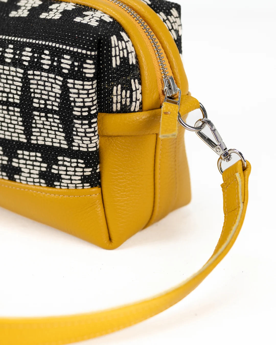 Yellow handbag with black and white patterned top section 