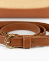 Brown leather belt with a gold buckle on a white background