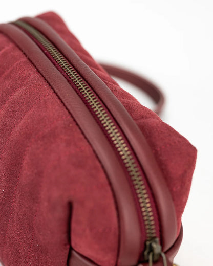 Red textured bag with a zipper on a white background