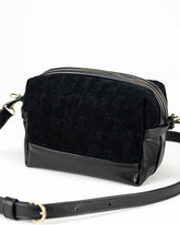 Black crossbody bag on a white background