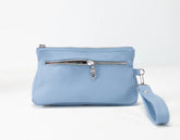 Light blue pouch with a zipper and wrist strap on a white background