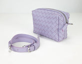 Lavender woven handbag with matching strap on a white background